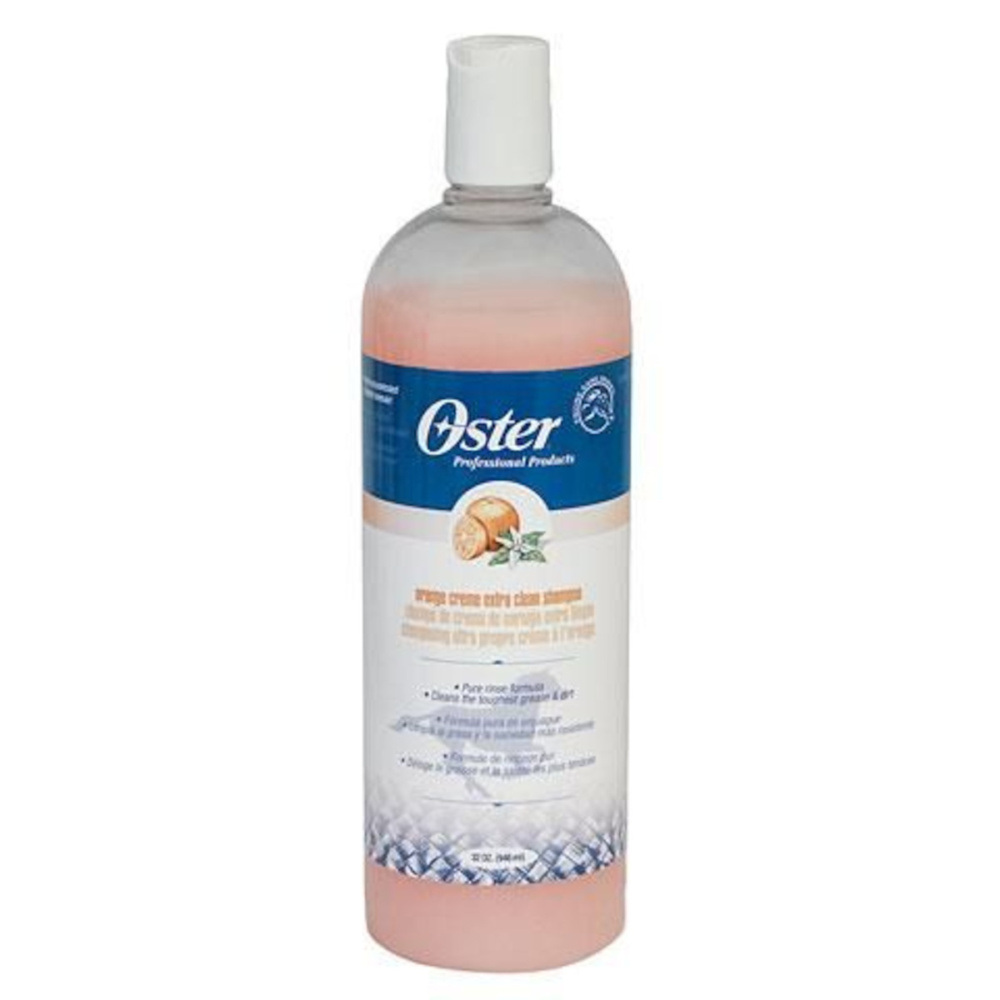 Shampoo Oster arancia Flacone trasparente Oster da 946 ml di shampoo Orange Creme, liquido pesca, tappo bianco e arancia sull'etichetta blu.